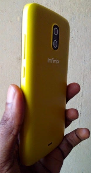 Infinix Hot in hand showing rear and side view