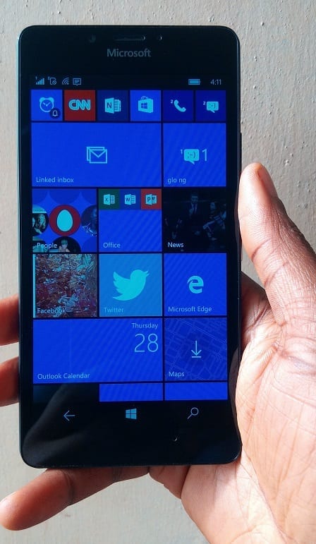 Lumia 950 in hand showing the Live Tiles
