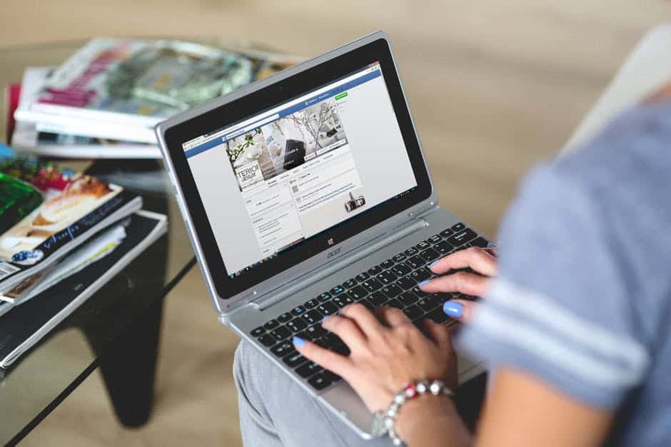 A woman typing on Laptop