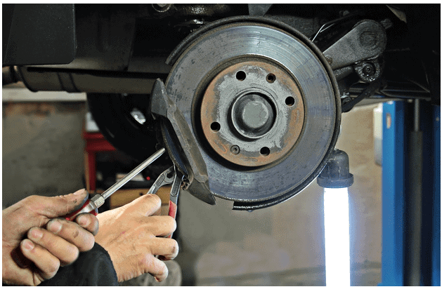 Mechanic at Work on Brake Disc