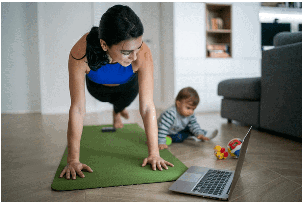 Woman Exercising while looking at a Laptop