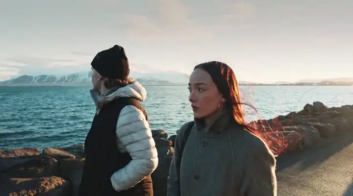 Photo of two people by the water's edge