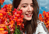 Best Portrait Camera Phone with Natural Background Blur in India? The OPPO Find X9 Ultra makes a strong case Photo of a smiling person among vibrant flowers
