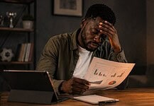 Five mistakes when reading sports statistics Man studies sports statistics on a printed report at a desk